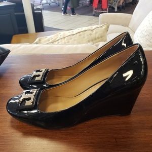 Tory Burch black patent leather wedge heel.